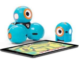 Dash and Dot sitting next to a tablet computer.